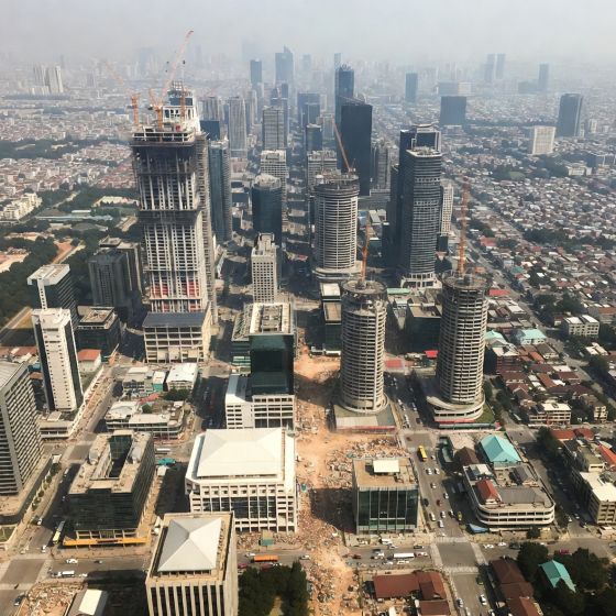 growing Asian city with construction zones